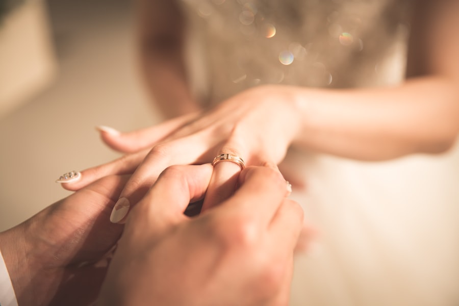 Styling imagery: a ring being slipped onto a bride's finger in golden light