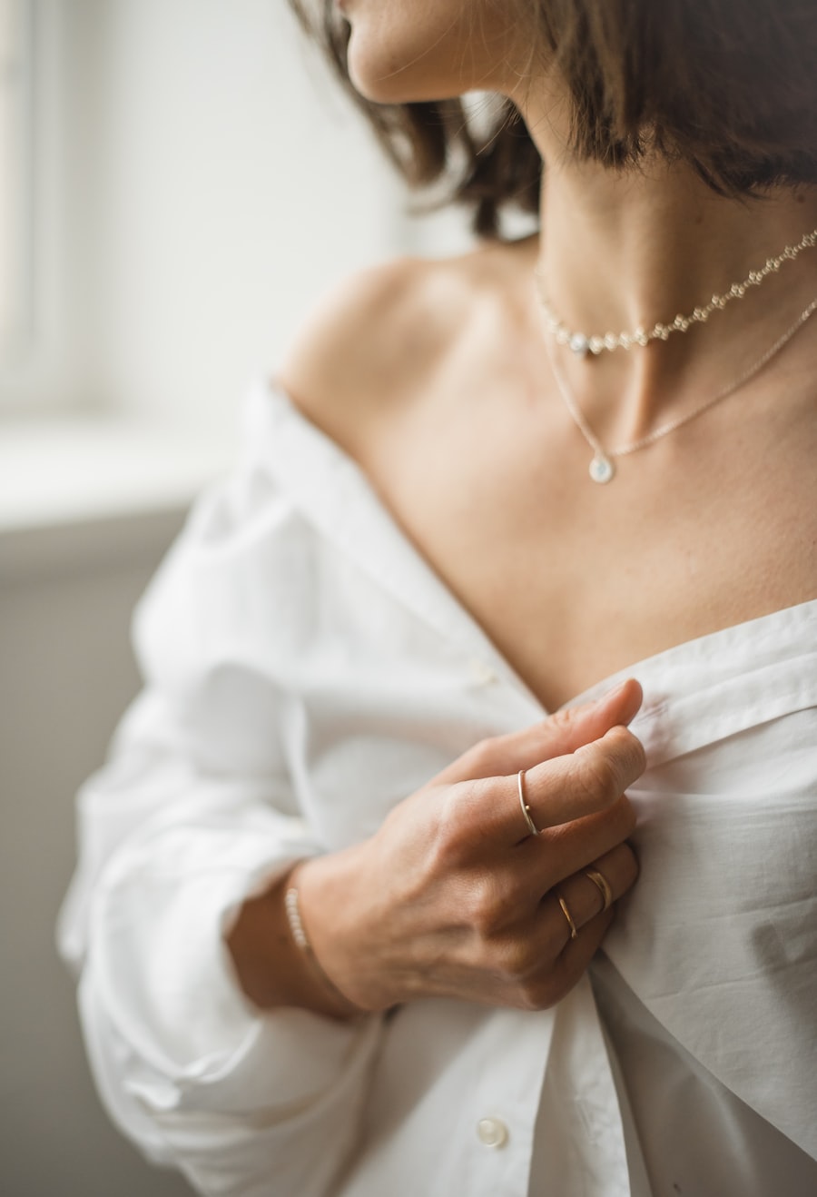 Styling imagery: a woman in white wearing delicate layered necklaces